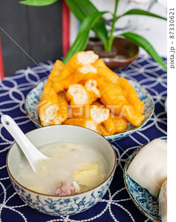 Close up shot of traditional breakfast with steamed bread, congee Close up shot of traditional breakfast with steamed bread, congee 87330621