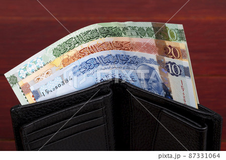 Libyan dinar in the black wallet 87331064