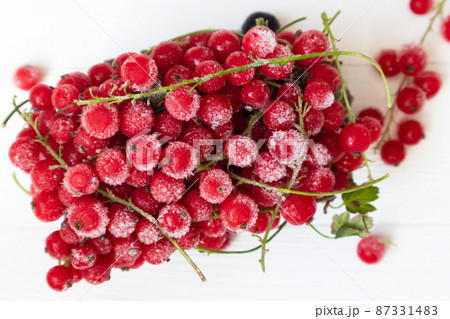 Frozen red and black currants in on a light background . The concept of preparing products for use in the future. 87331483