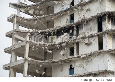 Closeup of demolished building on cloudy sky background 87331488