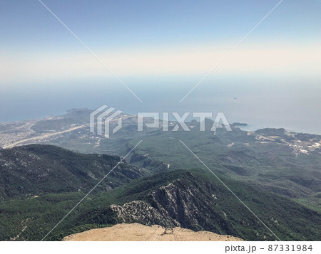 sandy high mountain. high mountain with plants in a warm country. vacation in the mountains. plants on the mountain. near the blue sea. landscape in a warm country 87331984