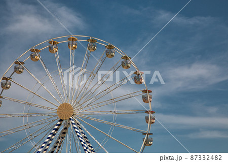 Ferris wheel against blue sky. 87332482