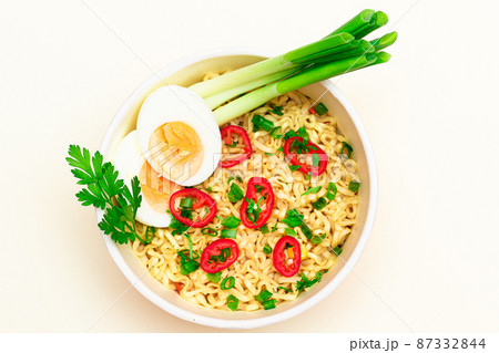 Beautiful Noodle Dish with Green Onions, Eggs, Red Hot Pepper and Greens Beautiful Noodle Dish with Green Onions, Eggs, Red Hot Pepper and Greens 87332844