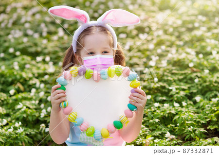 Easter in covid-19. Child in face mask, bunny ears 87332871