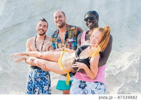 three multiracial young men with a girl in their arms three multiracial young men with a girl in their arms 87339882