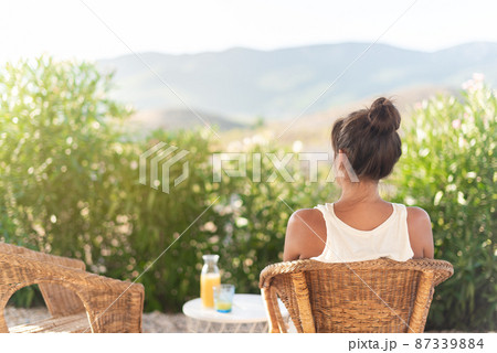 Rear view of an adult woman in rural home Rear view of an adult woman in rural home 87339884