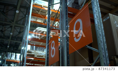 Warehouse with cardboard boxes inside on pallets racks, logistic center. Huge, large modern warehouse. Warehouse filled with cardboard boxes on shelves Warehouse with cardboard boxes inside on pallets racks, logistic center. Huge, large modern warehouse. Warehouse filled with cardboard boxes on shelves 87341173