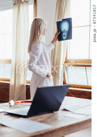 Woman Doctor Looking at X-Ray Radiography in hospital Woman Doctor Looking at X-Ray Radiography in hospital 87341817