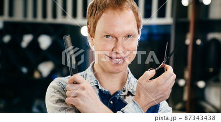 male hairdresser and stylist barbershop worker with scissors and comb male hairdresser and stylist barbershop worker with scissors and comb 87343438