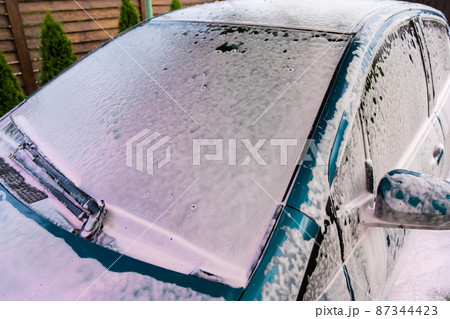 Car wash at home. The car is covered with foam to remove dirt Car wash at home. The car is covered with foam to remove dirt 87344423
