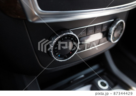 Turning on the air conditioning of a car on the climate control panel. Turning on the air conditioning of a car on the climate control panel. 87344429
