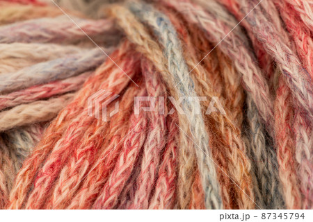 The Netherlands, February 2022. Close up of colored wool on a white background. 87345794