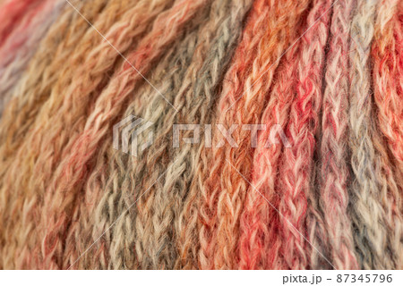 The Netherlands, February 2022. Close up of colored wool on a white background. 87345796