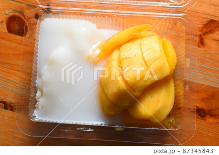Ripe mango with sticky rice in a plastic box 87345843