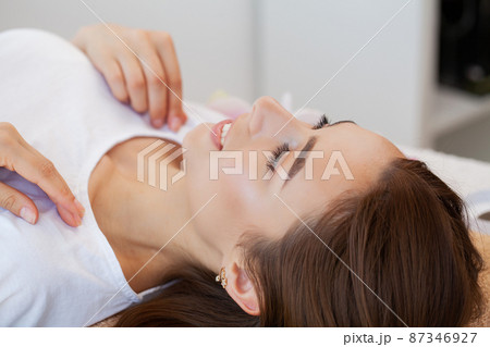 Beautiful girl has a facial massage in a beauty clinic. Beautiful girl has a facial massage in a beauty clinic. 87346927