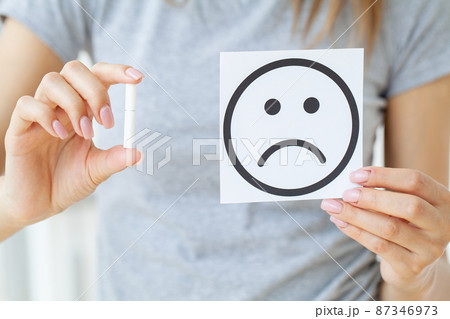 Stop smoking, woman holding a broken cigarette 87346973