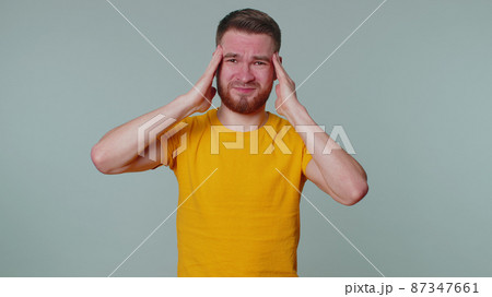 Man rubbing temples to cure headache problem, suffering from tension and migaine, stress, pain 87347661
