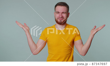 Man raising hands in indignant expression asking why what reason of failure demonstrating disbelief 87347697