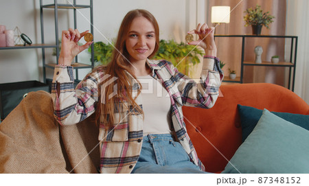Woman freelancer holding two gold coins BTC at home, successful developer programmer stock trader Woman freelancer holding two gold coins BTC at home, successful developer programmer stock trader 87348152