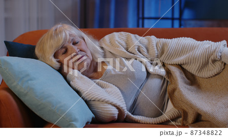 Scared tired senior woman wakes up from bad nightmare in bedroom at home, stress nervousness anxiety 87348822