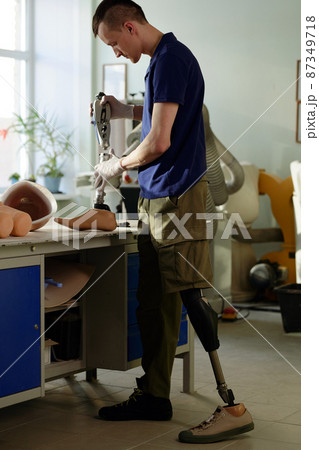 Worker of modern prosthetic production factory assembling new artificial limb Worker of modern prosthetic production factory assembling new artificial limb 87349718