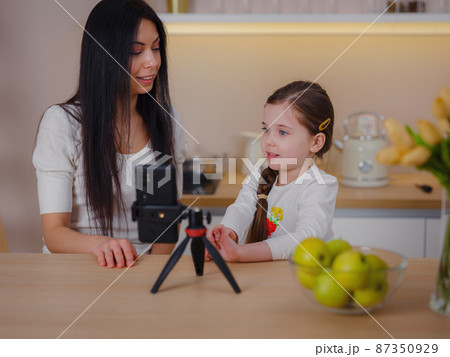 Blogger mom with her baby at home. Millennial Influencer woman creating content for her motherhood blog 87350929