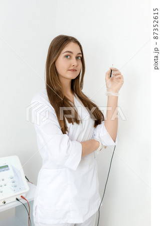 Beautician in the cosmetology office. Cosmetologist doctor with needle of electro epilation in a beauty clinic. Spa, beauty industry, treatment at salon, electrolysis. 87352615