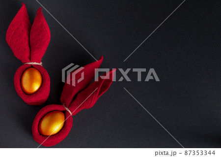 Luxurious golden Easter eggs. Festive decor on black background. Place for text. Luxurious golden Easter eggs. Festive decor on black background. Place for text. 87353344