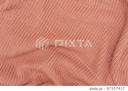 Texture of a pink knitted sweater close up Texture of a pink knitted sweater close up 87357417