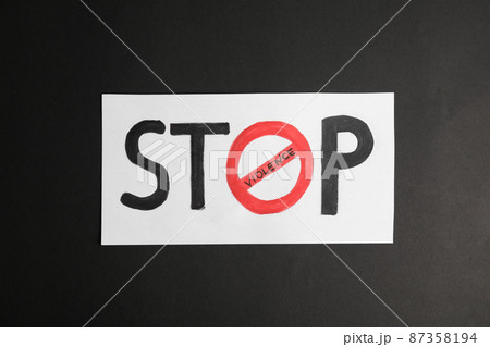 Phrase STOP VIOLENCE on black background, top view 87358194