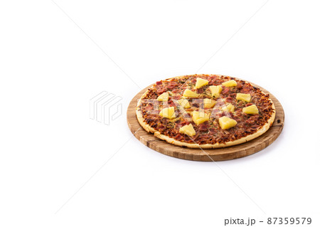 Hawaiian pizza with pineapple,ham and cheese isolated on white background Hawaiian pizza with pineapple,ham and cheese isolated on white background 87359579