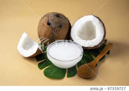Coconut oil with fresh nut. Healthy alternative oil for cooking and skin care. 87359727