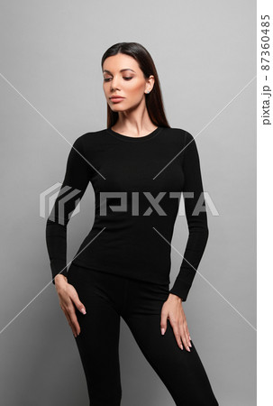 Woman wearing thermal underwear on grey background 87360485