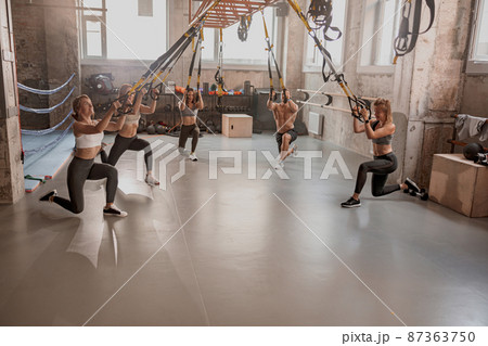 Group of sporty people training in fitness club 87363750