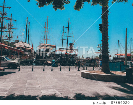 ships are in the bay with raised masts. ships for the travel of tourists and marine crews on the water. outdoor activities, deck diving ships are in the bay with raised masts. ships for the travel of tourists and marine crews on the water. outdoor activities, deck diving 87364020