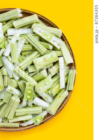 Moringa oleifera in bamboo weave plate on yellow background. Moringa oleifera in bamboo weave plate on yellow background. 87364305