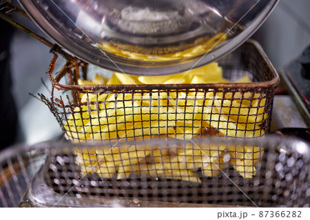 Dirty cooking area with french fries deep fryer. Dirty cooking area with french fries deep fryer. 87366282