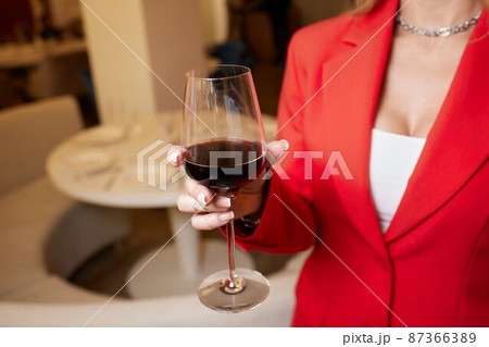 close-up of gorgeous woman with a glass of champagne. party and holiday celebration. 87366389