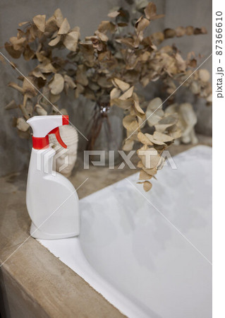 Cropped image of beautiful young woman using a duster and a detergent while cleaning sink and tap in bathroom. Cropped image of beautiful young woman using a duster and a detergent while cleaning sink and tap in bathroom. 87366610