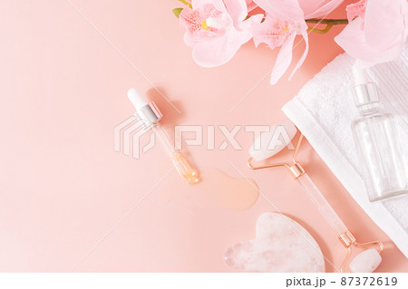 Massage tools on pink background with orchid Massage tools on pink background with orchid 87372619