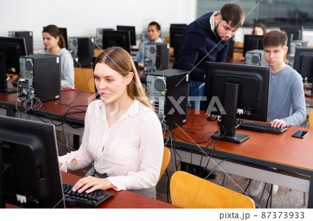Teacher conducts computer science exam in university class Teacher conducts computer science exam in university class 87373933