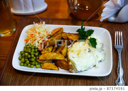 French style meat in Mornay sauce with vegetable garnish French style meat in Mornay sauce with vegetable garnish 87374591