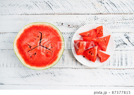 sweet fresh watermelon on white wooden background 87377815