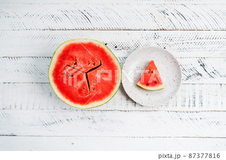 sweet fresh watermelon on white wooden background 87377816