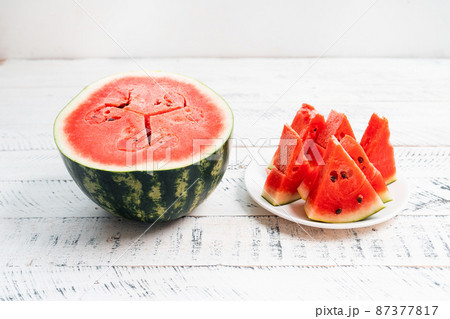 sweet fresh watermelon on white wooden background 87377817