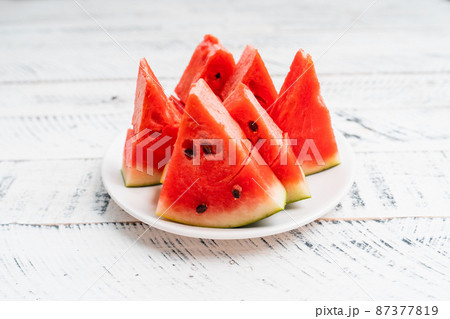 sweet fresh watermelon on white wooden background 87377819