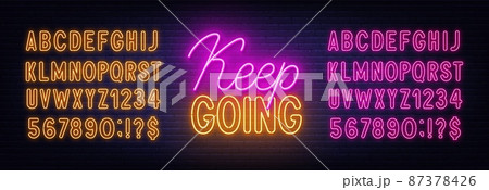 Keep going neon sign on brick wall background. 87378426
