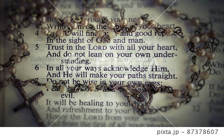 Top view of Bible verses with blurred Holy Rosary Background. Christianity concept Top view of Bible verses with blurred Holy Rosary Background. Christianity concept 87378607