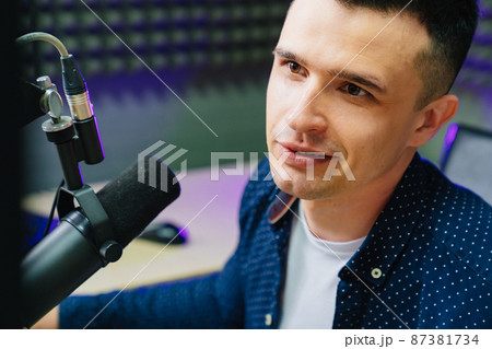 close up. professional radio host reading news and messages. close up. professional radio host reading news and messages. 87381734