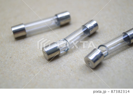 Broken electrical fuses with split glass housing. Broken glass tube. Hot-melt fuse for electrical appliances. Selective focus 87382314